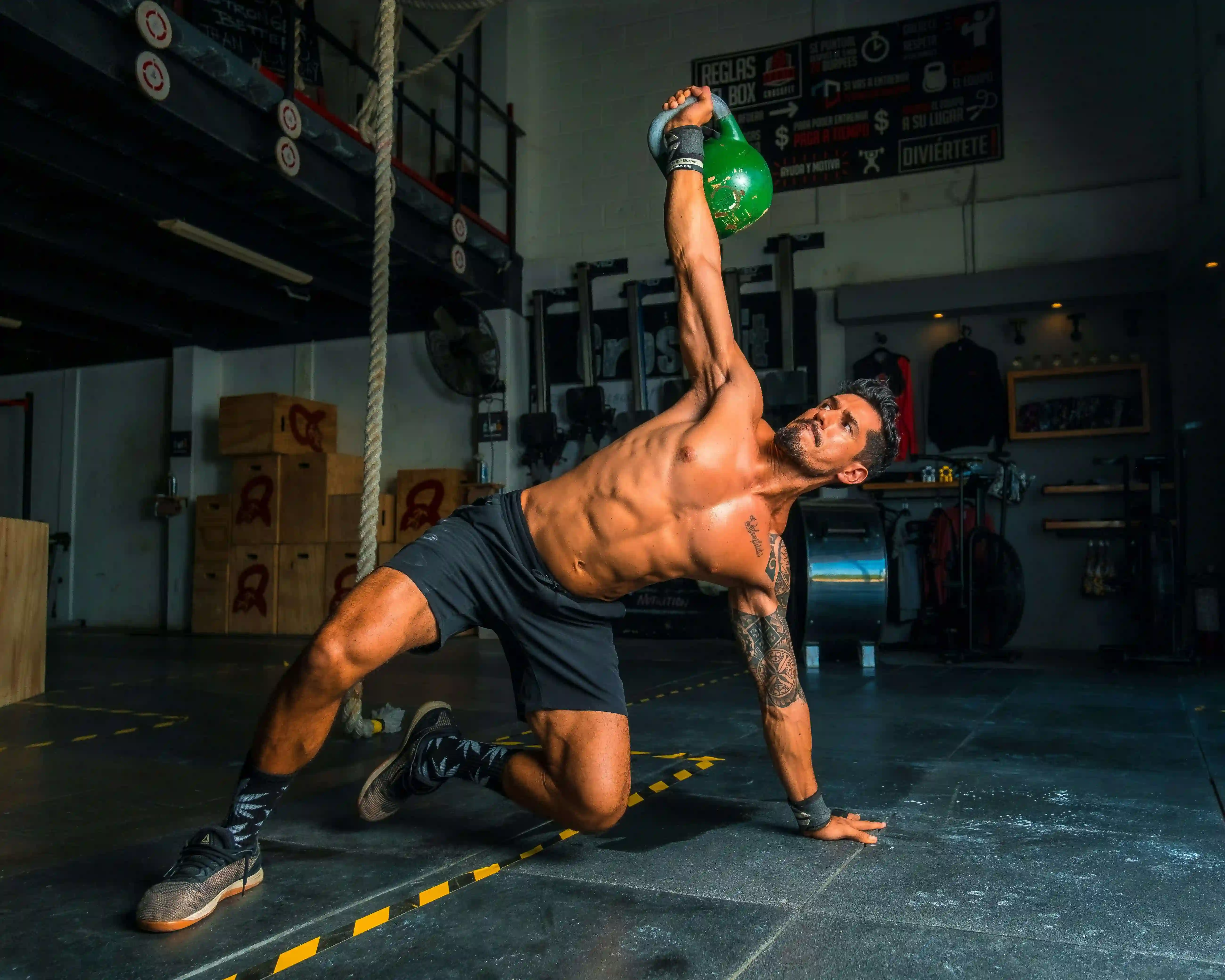A man performing a turkish get up with a kettlebell